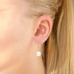 Ovale 7 - 8 mm aaa-graded ferskvandsperle øreringe i 14 karat guld med 